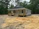 Charming single-story home featuring a welcoming front porch and light gray siding, nestled in a wooded setting at 604 Natchez Trace, Fuquay Varina, NC 27526