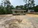 Quaint home with inviting front porch, nestled amongst trees, with a neighboring house in the distance at 604 Natchez Trace, Fuquay Varina, NC 27526