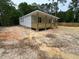 Cozy one-story home with a spacious wooden front porch, surrounded by lush trees and a natural landscape at 604 Natchez Trace, Fuquay Varina, NC 27526