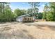 Beautifully landscaped single-story home with a charming covered porch, surrounded by lush greenery at 604 Natchez Trace, Fuquay Varina, NC 27526