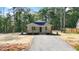 Inviting single-story home featuring a covered front porch, set amidst a serene wooded landscape at 604 Natchez Trace, Fuquay Varina, NC 27526