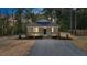 Charming single-story home with a cozy front porch and fresh gravel driveway nestled among mature trees at 604 Natchez Trace, Fuquay Varina, NC 27526