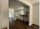 Open-concept kitchen featuring bright white cabinetry, wood-look floors, and backyard access at 604 Natchez Trace, Fuquay Varina, NC 27526