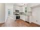 Modern kitchen featuring stainless steel appliances, stylish white cabinets, and granite countertops at 604 Natchez Trace, Fuquay Varina, NC 27526