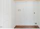 Clean laundry room with wood-look floors and white walls at 604 Natchez Trace, Fuquay Varina, NC 27526