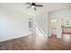 Bright living room featuring hardwood floors, ceiling fan, and access to the kitchen and outdoor space at 604 Natchez Trace, Fuquay Varina, NC 27526
