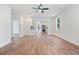 Open-concept living room with hardwood floors, white trim, and lots of natural light, with access to the kitchen at 604 Natchez Trace, Fuquay Varina, NC 27526