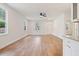 Bright, open-concept living room with beautiful wood floors, ample natural light, and modern ceiling fan at 604 Natchez Trace, Fuquay Varina, NC 27526