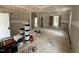 Unfinished living room with drywall, paint supplies, and an open floor plan, awaiting your personal touch at 604 Natchez Trace, Fuquay Varina, NC 27526