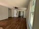 Spacious living room with sleek, modern ceiling fan and beautiful wood-look floors at 604 Natchez Trace, Fuquay Varina, NC 27526