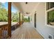 Spacious covered porch with wooden railings and ceiling fans, offering a welcoming outdoor space at 604 Natchez Trace, Fuquay Varina, NC 27526