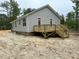 New home exterior featuring a wooden deck with stairs and light gray siding at 604 Natchez Trace, Fuquay Varina, NC 27526