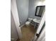 Cozy half-bathroom featuring tiled floor, a pedestal sink, toilet, and framed mirror at 607 Wahlbrink Dr, Wake Forest, NC 27587