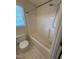 Bathroom featuring a tub and shower combination with a window and tile floors at 607 Wahlbrink Dr, Wake Forest, NC 27587