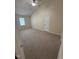 This bedroom features neutral carpeting, a ceiling fan, a window, and a closet door at 607 Wahlbrink Dr, Wake Forest, NC 27587