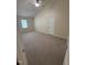 Bedroom featuring neutral carpet, a window, and a door, creating a comfortable and inviting space at 607 Wahlbrink Dr, Wake Forest, NC 27587