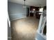 Dining room featuring tile floors and access to the kitchen with an island and dark wood cabinets at 607 Wahlbrink Dr, Wake Forest, NC 27587