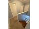 Hallway featuring carpet, white doors and trim, and light grey walls as viewed from the top of a staircase at 607 Wahlbrink Dr, Wake Forest, NC 27587