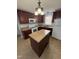 Traditional kitchen featuring a center island, dark cabinetry, a white oven, and countertops at 607 Wahlbrink Dr, Wake Forest, NC 27587