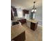 Functional kitchen with island, white appliances, dark wood cabinets, and access to an open area at 607 Wahlbrink Dr, Wake Forest, NC 27587