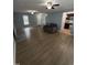 Spacious living room featuring new floors, large windows, and ceiling fans at 607 Wahlbrink Dr, Wake Forest, NC 27587