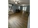 Open-concept living room with hardwood floors, ceiling fans, and stairs at 607 Wahlbrink Dr, Wake Forest, NC 27587