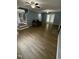 Spacious living room features updated floors, ceiling fans, and a cozy couch near the entrance at 607 Wahlbrink Dr, Wake Forest, NC 27587