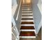 A staircase features wood treads, white risers, and a light gray wall, offering a classic and inviting design at 607 Wahlbrink Dr, Wake Forest, NC 27587