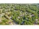 Aerial view showcasing a neighborhood with tree-lined streets and multiple residential homes at 608 Driftwood Dr, Gibsonville, NC 27249