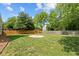 Spacious backyard features a neatly landscaped yard, a fire pit, and a wood fence at 608 Driftwood Dr, Gibsonville, NC 27249