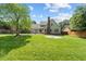 Spacious backyard featuring a well-manicured lawn and a charming fire pit area at 608 Driftwood Dr, Gibsonville, NC 27249