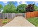 Large backyard with manicured lawn, partial fencing, and an entertainment area for Gathering activities at 608 Driftwood Dr, Gibsonville, NC 27249