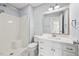 Modern bathroom with white vanity, toilet, shower, and tiled floors in a light, airy space at 608 Driftwood Dr, Gibsonville, NC 27249