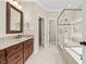 Bathroom with double sink vanity, granite countertop, and glass enclosed shower and soaking tub at 608 Driftwood Dr, Gibsonville, NC 27249