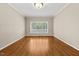 Bedroom with hardwood floors, bright light fixture and large windows at 608 Driftwood Dr, Gibsonville, NC 27249