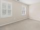 This bedroom features carpet flooring and plenty of natural light through windows with plantation shutters at 608 Driftwood Dr, Gibsonville, NC 27249