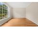 Bedroom featuring hardwood floors and large windows at 608 Driftwood Dr, Gibsonville, NC 27249