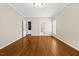 Bedroom with hardwood floors, bright light fixture and doors to ensuite bathroom and storage at 608 Driftwood Dr, Gibsonville, NC 27249