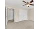 Bedroom with carpet and fan boasts natural light from shuttered windows, offering a peaceful retreat at 608 Driftwood Dr, Gibsonville, NC 27249