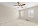 Bedroom with carpet and fan boasts natural light from shuttered windows, offering a peaceful retreat at 608 Driftwood Dr, Gibsonville, NC 27249