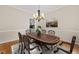 Elegant dining room features a chandelier, a large table with chairs, and a scenic painting at 608 Driftwood Dr, Gibsonville, NC 27249