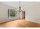 Dining room featuring hardwood floors, chandelier and a large window with natural light at 608 Driftwood Dr, Gibsonville, NC 27249