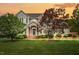 Charming two-story home boasts a manicured lawn and inviting front entrance at sunset at 608 Driftwood Dr, Gibsonville, NC 27249