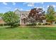 Charming home features a manicured lawn, decorative shrubbery, and a welcoming front entrance at 608 Driftwood Dr, Gibsonville, NC 27249
