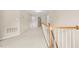 Second floor hallway featuring carpet, decorative railing, and access to many rooms at 608 Driftwood Dr, Gibsonville, NC 27249
