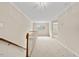 Second floor hallway featuring carpet, decorative railing, and natural light at 608 Driftwood Dr, Gibsonville, NC 27249