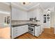 Modern kitchen with stainless steel appliances, white cabinetry, and hardwood floors at 608 Driftwood Dr, Gibsonville, NC 27249