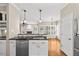 Bright kitchen featuring granite countertops, stainless steel appliances, and pendant lighting at 608 Driftwood Dr, Gibsonville, NC 27249