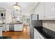 Bright kitchen featuring white cabinets, stainless steel appliances, hardwood floors, and a center island at 608 Driftwood Dr, Gibsonville, NC 27249