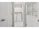 Neat laundry room with modern appliances, white cabinets, and white tiled flooring at 608 Driftwood Dr, Gibsonville, NC 27249